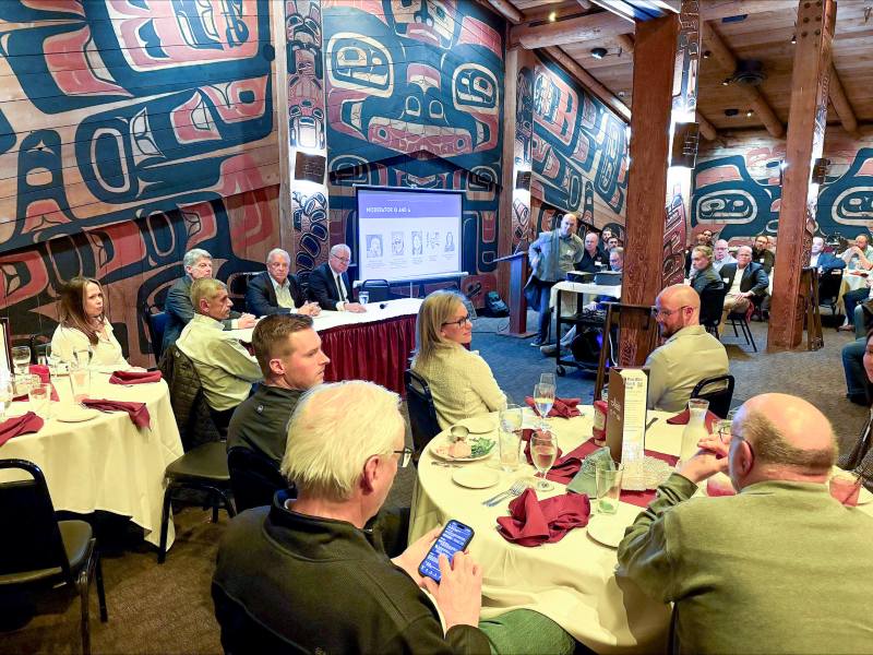 Photo of people seated as three Harborview Bond team members present to people attending the Construction Management Association of America Pacific Northwest Chapter meeting.